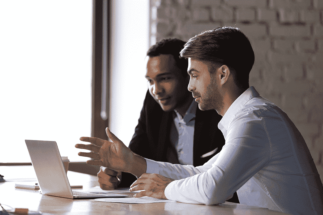 two facilities managers reviewing their operational data on a laptop[1]-min