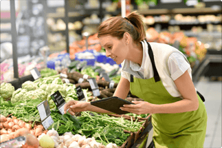 woman checking food at a grocery store - food quality assurance