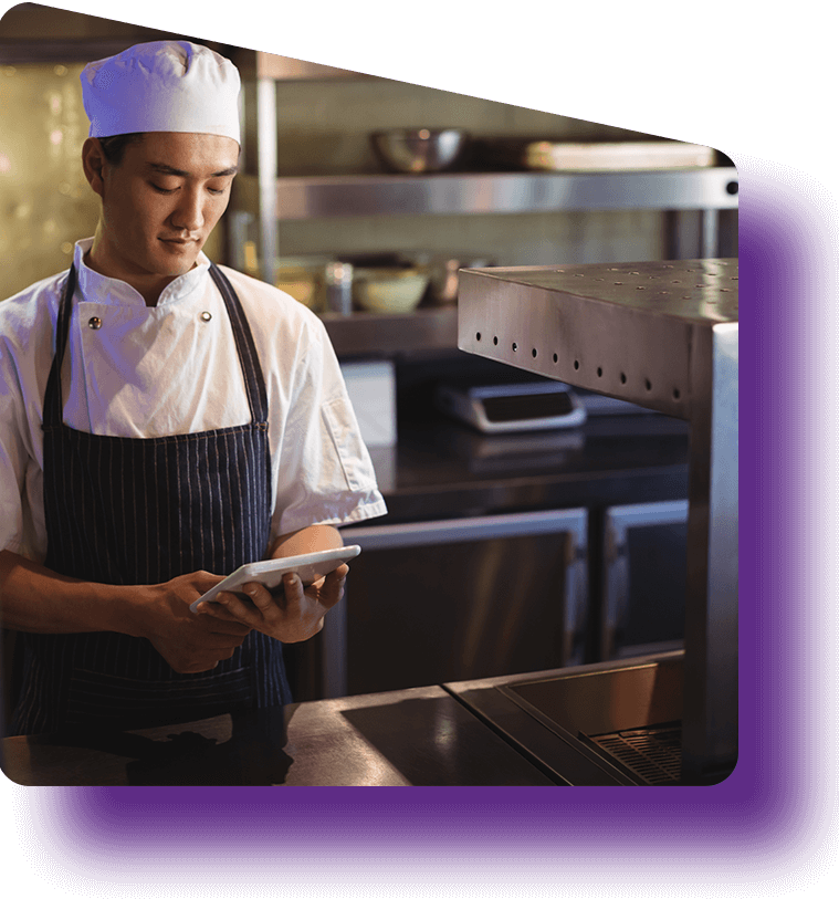 A chef in the kitchen using mpro5 on a tablet