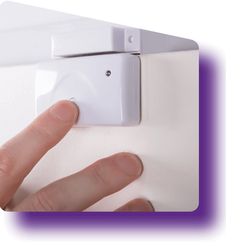 The hand of someone testing an IoT door sensor