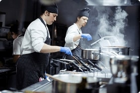 Two-chefs-working-hard-in-kitchen