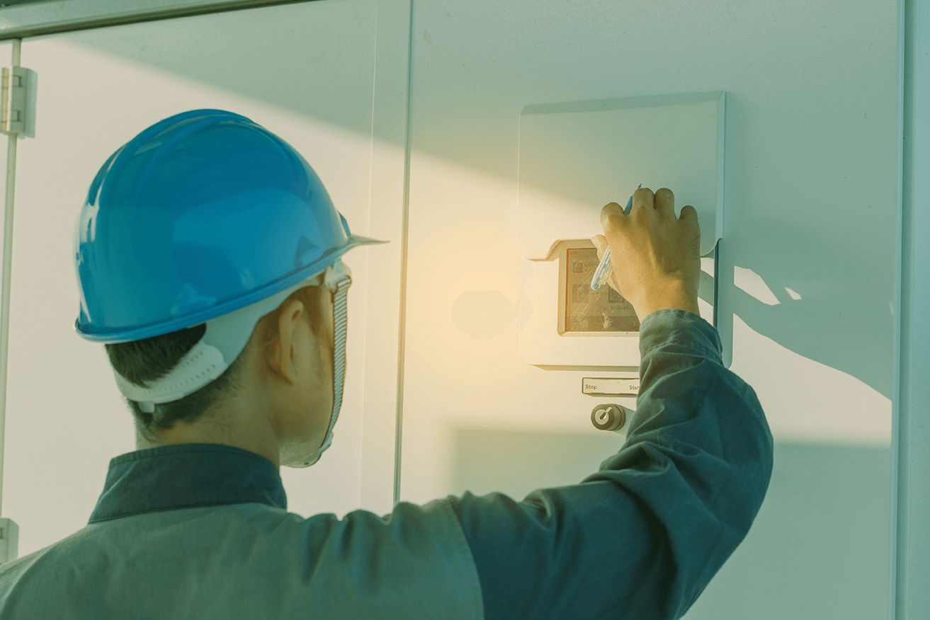 a maintenance worker checking a HVAC control panel