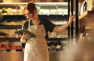 employee-checking-tablet-in-supermarket