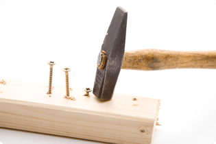 hammering-screws-into-a-plank