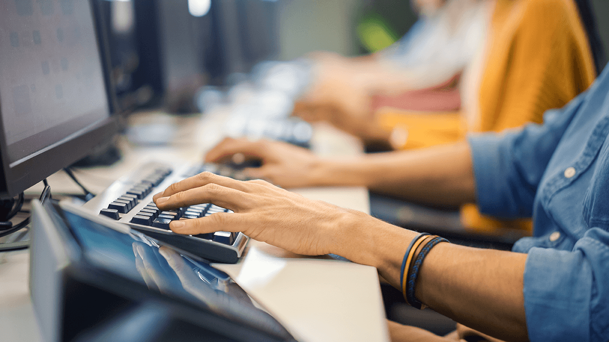 A close-up shot of someones hands typing