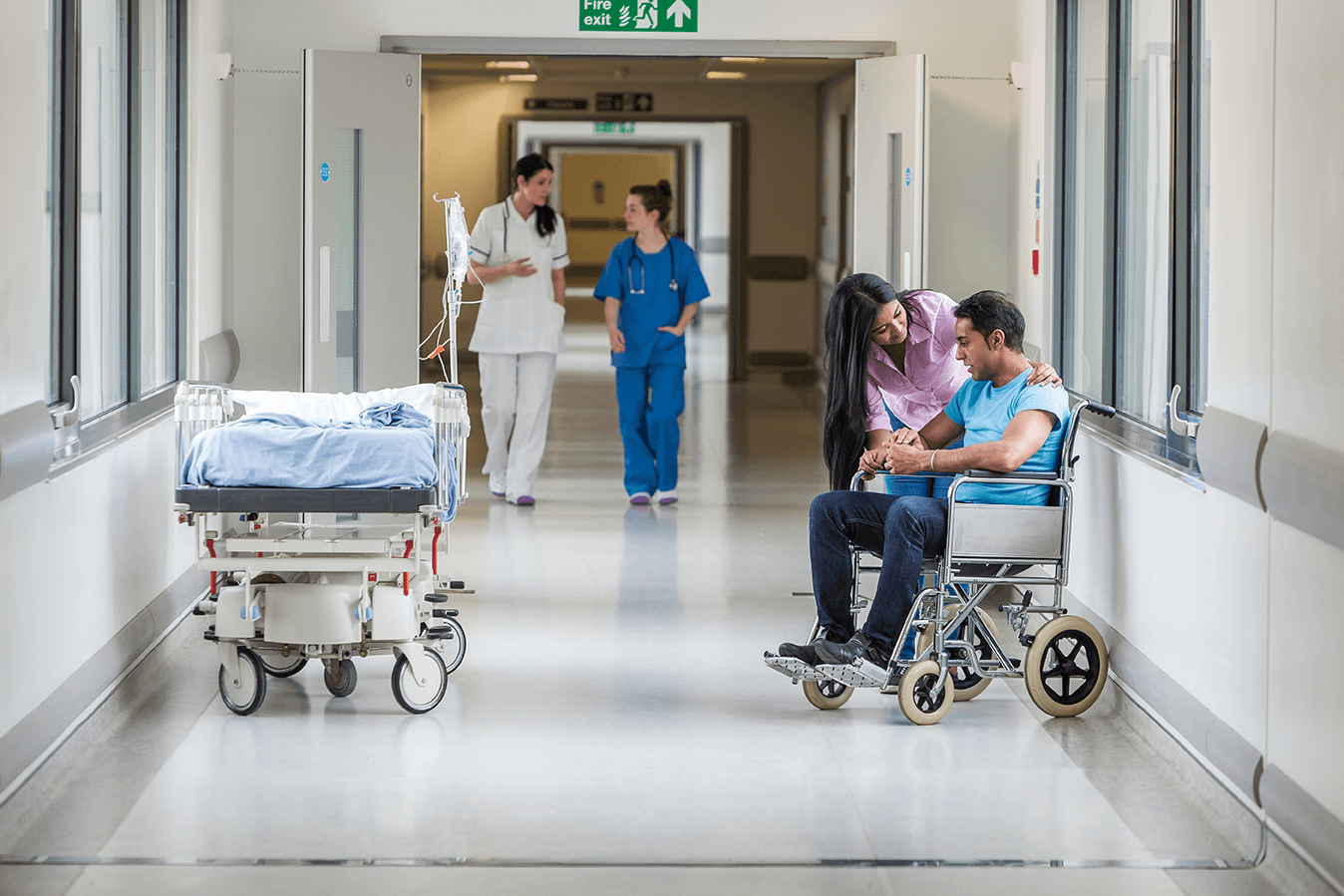 Hospital-corridor-doctors-and-nurse-checking-patient