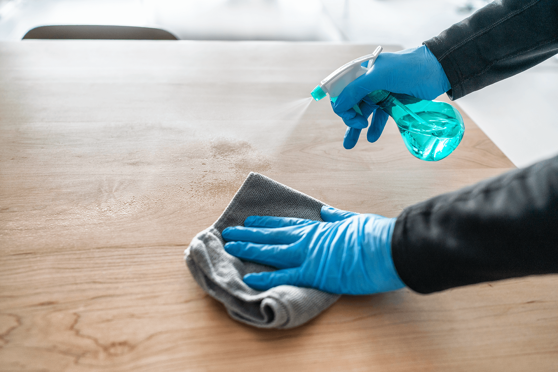 a close up shot of a cleaner wiping a table