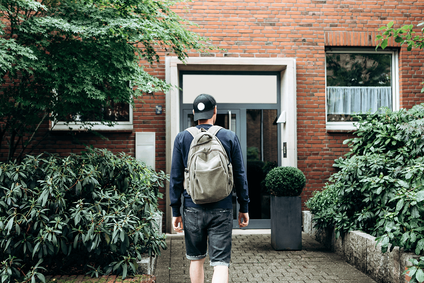 a student walking to the front door of their accomodation block