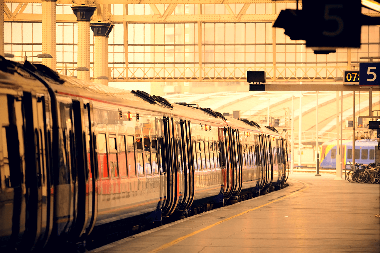 a train pulls into the station at sunset
