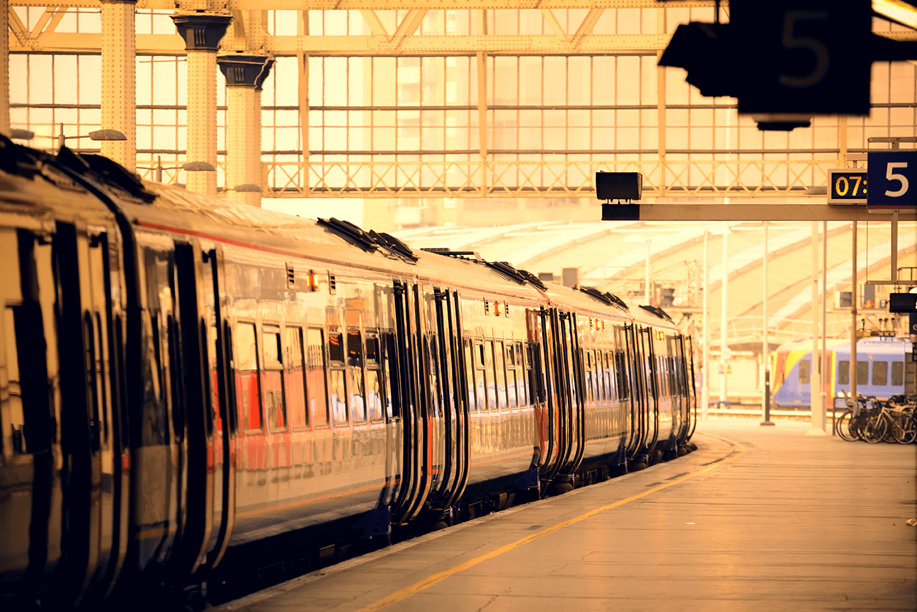 a train pulls into the station at sunset a train pulls into the station at sunset