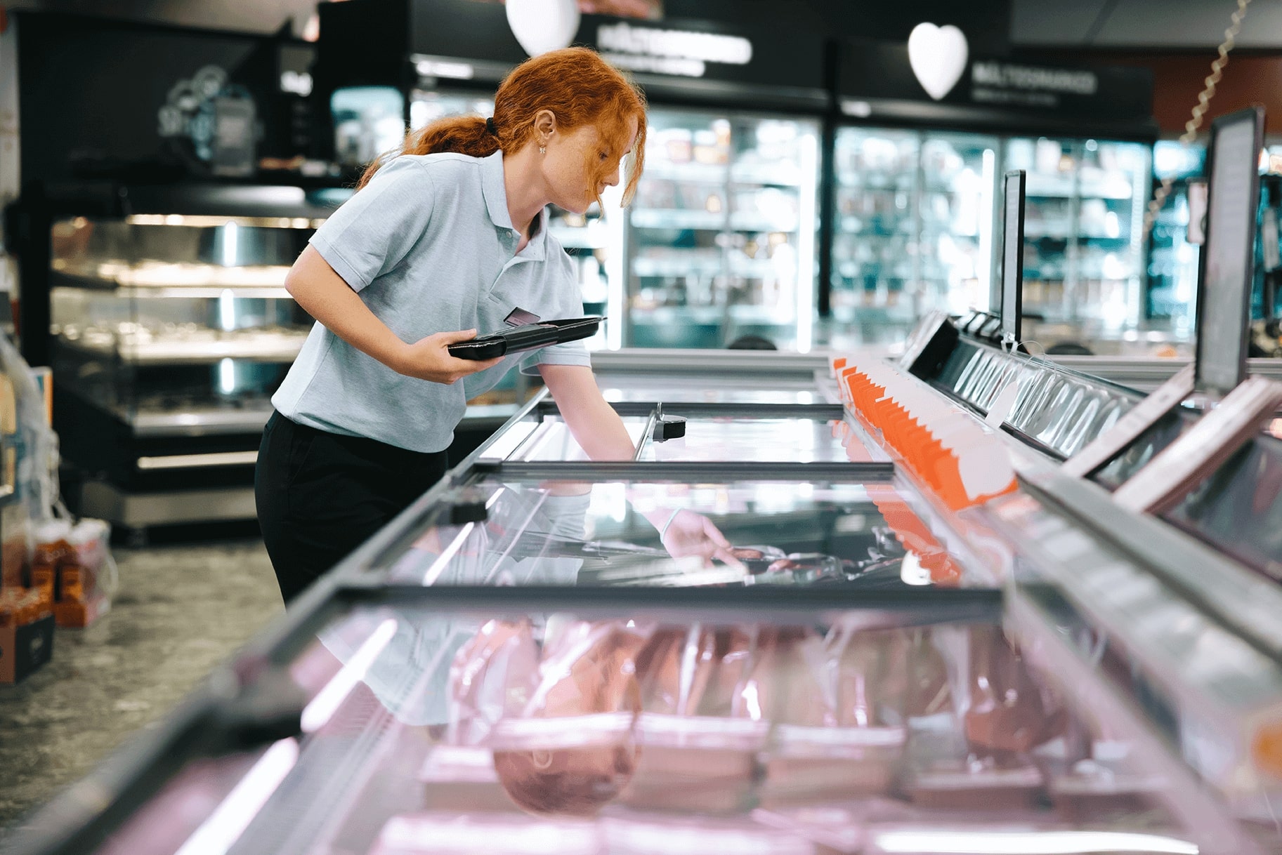 employee-restocks-freezer-supermarket-retail