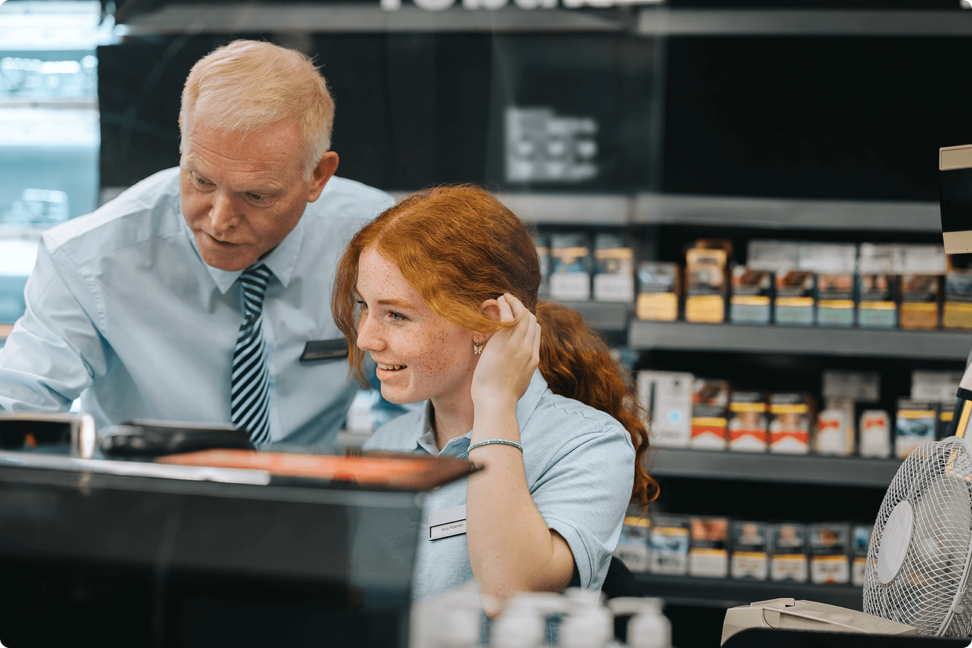 manager-teaches-supermarket-employee-new-system